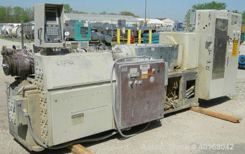 Used Cincinnati Milicron Conical Counter-Rotating Twin Screw Extruder, 80 mm, model CM80HP. Electrically heated, water cooled vented barrel with pump. Water cooled feed throat with a crammer feeder. ...