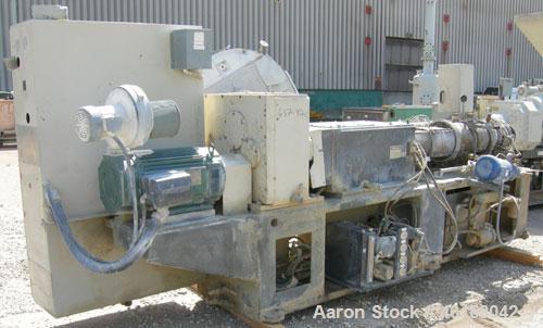 Used Cincinnati Milicron Conical Counter-Rotating Twin Screw Extruder, 80 mm, model CM80HP. Electrically heated, water cooled vented barrel with pump. Water cooled feed throat with a crammer feeder. ...