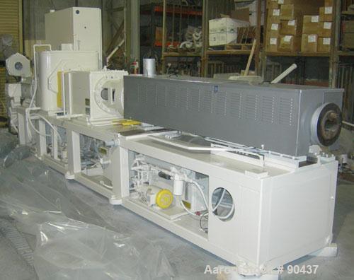 USED: Cincinnati counter-rotating twin screw extruder, 92 mm, model CM92HP. Electrically heated, water cooled 5 zone top vented barrel with tank, heat exchanger and pump. Built-in oil cooling/heating...