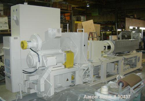 USED: Cincinnati counter-rotating twin screw extruder, 92 mm, model CM92HP. Electrically heated, water cooled 5 zone top vented barrel with tank, heat exchanger and pump. Built-in oil cooling/heating...