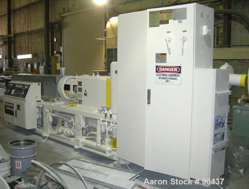 USED: Cincinnati counter-rotating twin screw extruder, 92 mm, model CM92HP. Electrically heated, water cooled 5 zone top vented barrel with tank, heat exchanger and pump. Built-in oil cooling/heating...
