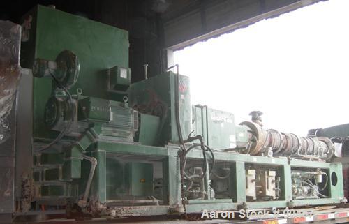 USED: Cincinnati counter-rotating twin screw extruder, 92 mm, model CM92HP. Electrically heated, water cooled 5 zone top vented barrel with tank, heat exchanger and pump. Built-in oil cooling/heating...
