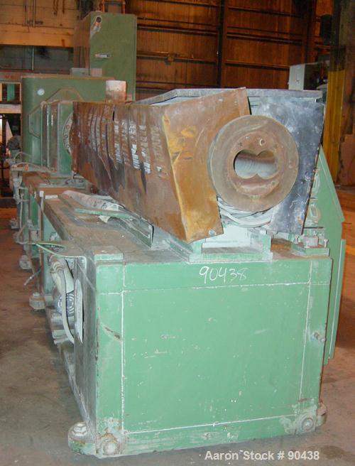 USED: Cincinnati counter-rotating twin screw extruder, 92 mm, model CM92HP. Electrically heated, water cooled 5 zone top vented barrel with tank, heat exchanger and pump. Built-in oil cooling/heating...