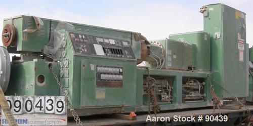 USED: Cincinnati counter-rotating twin screw extruder, 92 mm, model CM92HP. Electrically heated, water cooled 5 zone top vented barrel with tank, heat exchanger and pump. Built-in oil cooling/heating...
