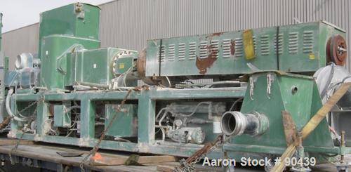 USED: Cincinnati counter-rotating twin screw extruder, 92 mm, model CM92HP. Electrically heated, water cooled 5 zone top vented barrel with tank, heat exchanger and pump. Built-in oil cooling/heating...