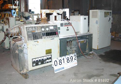 USED: Cincinnati Milacron Model CM-55HP Conical Twin Screw Counter-Rotating Extruder having an electrically heated, liquid cooled and vented barrel at an approximate 42" centerline height. Gearbox is...