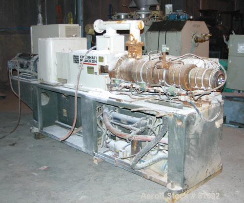 USED: Cincinnati Milacron Model CM-55HP Conical Twin Screw Counter-Rotating Extruder having an electrically heated, liquid cooled and vented barrel at an approximate 42" centerline height. Gearbox is...