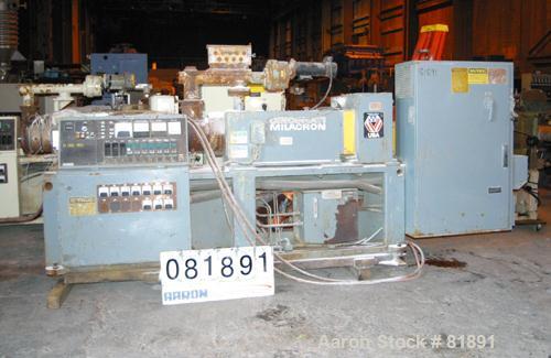 USED: Cincinnati Milacron Model CM-65HP Conical Twin Screw Counter-Rotating Extruder having an electrically heated, liquid cooled and vented barrel at an approximate 42" centerline height. Gearbox is...