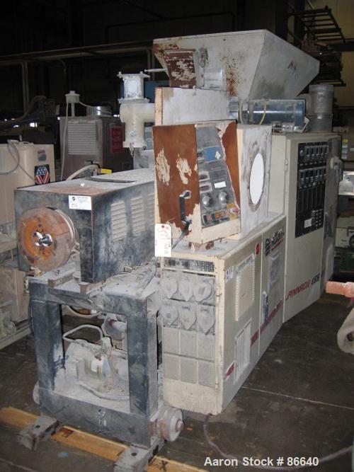 USED: Cincinnati Milacron twin screw extruder, model E55 Pinnacle. 55 mm conical screws, counter rotating, 21:1 L/D, electrically heated, water cooled, vented barrel with vacuum pump, 40 hp DC motor ...