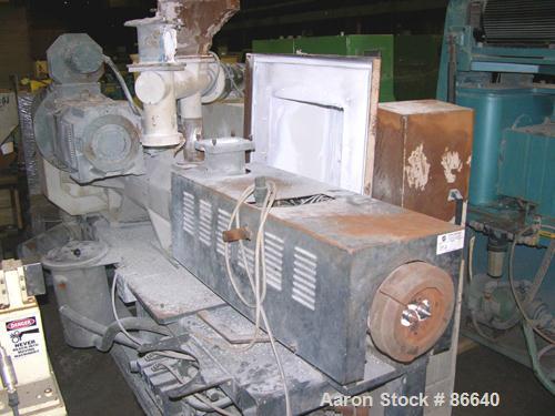 USED: Cincinnati Milacron twin screw extruder, model E55 Pinnacle. 55 mm conical screws, counter rotating, 21:1 L/D, electrically heated, water cooled, vented barrel with vacuum pump, 40 hp DC motor ...