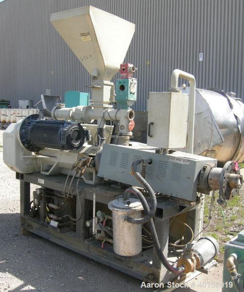 Used Cincinnati Milicron Conical Counter-Rotating Twin Screw Extruder, 55 mm, model E55 Pinnacle. Electrically heated, water cooled 4 zone vented barrel with pump. Water cooled feed throat with a dos...