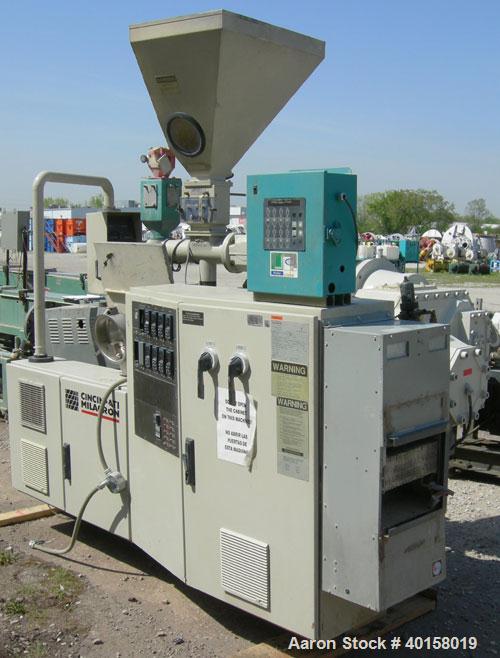 Used Cincinnati Milicron Conical Counter-Rotating Twin Screw Extruder, 55 mm, model E55 Pinnacle. Electrically heated, water cooled 4 zone vented barrel with pump. Water cooled feed throat with a dos...