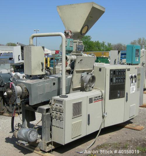 Used Cincinnati Milicron Conical Counter-Rotating Twin Screw Extruder, 55 mm, model E55 Pinnacle. Electrically heated, water cooled 4 zone vented barrel with pump. Water cooled feed throat with a dos...