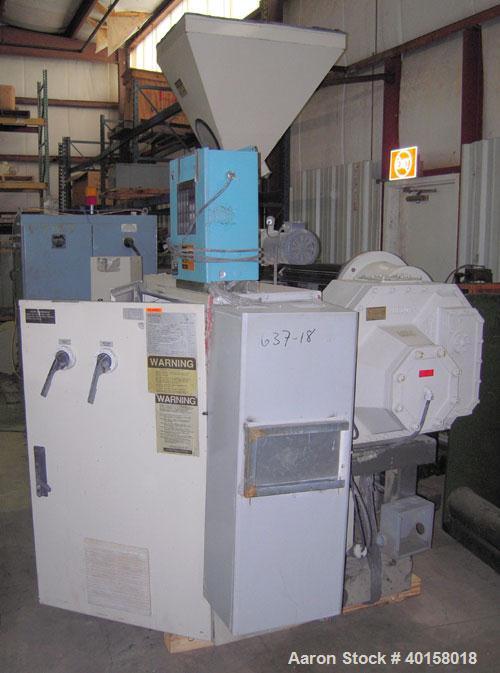Used Cincinnati Milicron Conical Counter-Rotating Twin Screw Extruder, 55 mm, model E55 Pinnacle. Electrically heated, water cooled vented barrel with pump. Water cooled feed throat with a dosing fee...