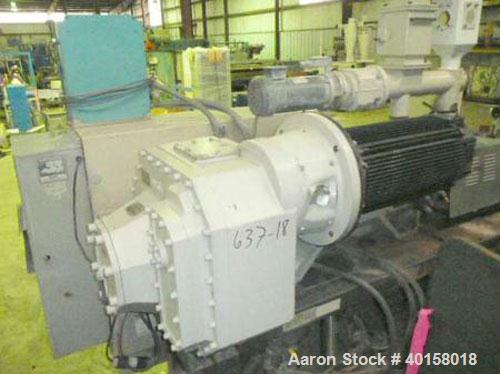 Used Cincinnati Milicron Conical Counter-Rotating Twin Screw Extruder, 55 mm, model E55 Pinnacle. Electrically heated, water cooled vented barrel with pump. Water cooled feed throat with a dosing fee...
