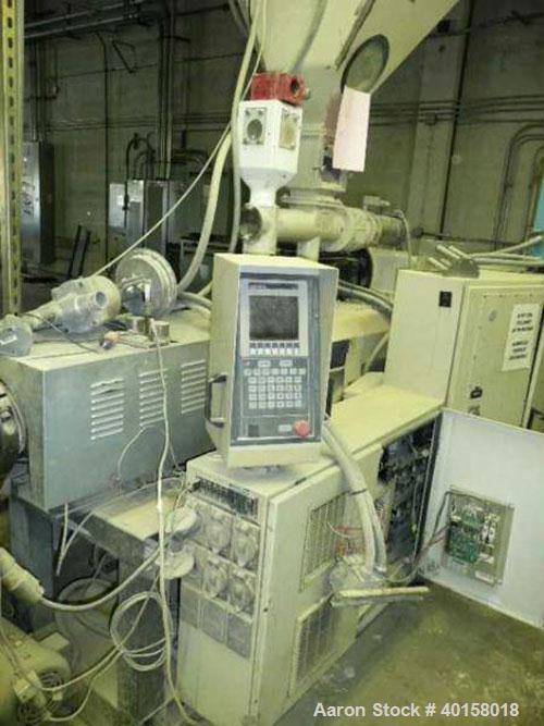 Used Cincinnati Milicron Conical Counter-Rotating Twin Screw Extruder, 55 mm, model E55 Pinnacle. Electrically heated, water cooled vented barrel with pump. Water cooled feed throat with a dosing fee...