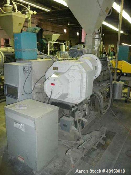 Used Cincinnati Milicron Conical Counter-Rotating Twin Screw Extruder, 55 mm, model E55 Pinnacle. Electrically heated, water cooled vented barrel with pump. Water cooled feed throat with a dosing fee...