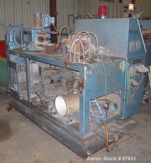 Used Krauss Maffei 50mm Counter-Rotating Twin Screw Extruder, Type KMD-2-50KK. (2) 50 mm diameter screws. Dosing feeder. Gearbox is direct driven by a 30 hp DC motor. Integral panel has 8 zones of di...