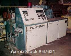 Used Krauss Maffei 50mm Counter-Rotating Twin Screw Extruder, Type KMD-2-50KK. (2) 50 mm diameter screws. Dosing feeder. Gearbox is direct driven by a 30 hp DC motor. Integral panel has 8 zones of di...