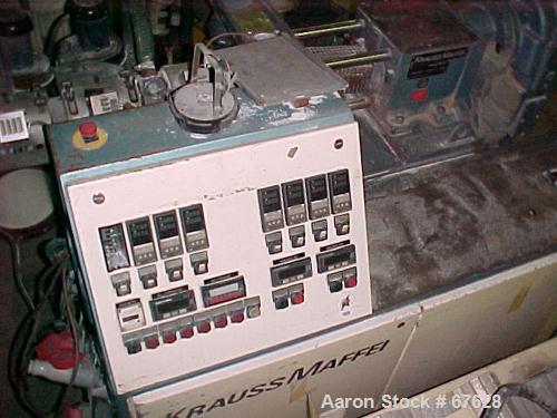 Used Krauss Maffei 40mm Counter-Rotating Twin Screw Extruder, Type KMD2-40KK. (2) 40 mm diameter screws. Gearbox is direct driven by a 25 hp DC motor. Integral panel has 8 zones of RKC digital contro...