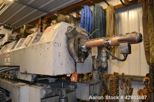 Used Ikegai 65mm Twin Screw Extruder, Model PCM-65II. Liquid heated, and cooled. 8 Zone top vented barrel. Top mounted twin screw feeder. Approximate 64" centerline height. Extruder driven by a 75kw ...