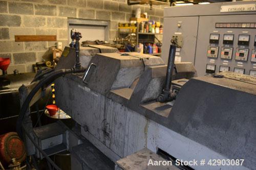 Used Ikegai 65mm Twin Screw Extruder, Model PCM-65II. Liquid heated, and cooled. 8 Zone top vented barrel. Top mounted twin screw feeder. Approximate 64" centerline height. Extruder driven by a 75kw ...