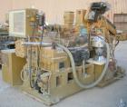 USED: Amut twin screw extruder, 92 mm screw diameter, model BA92. Approximate 24:1 L/D ratio. Counter-rotating screw design. 6 zone top vented, electrically heated, air cooled barrel with vacuum pump...