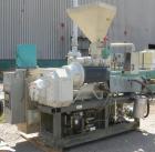 Used Cincinnati Milicron Conical Counter-Rotating Twin Screw Extruder, 55 mm, model E55 Pinnacle. Electrically heated, water cooled 4 zone vented barrel with pump. Water cooled feed throat with a dos...