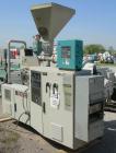 Used Cincinnati Milicron Conical Counter-Rotating Twin Screw Extruder, 55 mm, model E55 Pinnacle. Electrically heated, water cooled 4 zone vented barrel with pump. Water cooled feed throat with a dos...