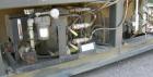 Used Cincinnati Milicron Conical Counter-Rotating Twin Screw Extruder, 55 mm, model E55 Pinnacle. Electrically heated, water cooled 4 zone vented barrel with pump. Water cooled feed throat with a dos...