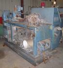 Used Krauss Maffei 50mm Counter-Rotating Twin Screw Extruder, Type KMD-2-50KK. (2) 50 mm diameter screws. Dosing feeder. Gearbox is direct driven by a 30 hp DC motor. Integral panel has 8 zones of di...