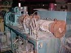 Used Krauss Maffei 50mm Counter-Rotating Twin Screw Extruder, Type KMD-2-50KK. (2) 50 mm diameter screws. Dosing feeder. Gearbox is direct driven by a 30 hp DC motor. Integral panel has 8 zones of di...