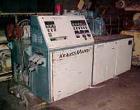 Used Krauss Maffei 50mm Counter-Rotating Twin Screw Extruder, Type KMD-2-50KK. (2) 50 mm diameter screws. Dosing feeder. Gearbox is direct driven by a 30 hp DC motor. Integral panel has 8 zones of di...