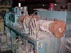 Used Krauss Maffei 50mm Counter-Rotating Twin Screw Extruder, Type KMD-2-50KK. (2) 50 mm diameter screws. Dosing feeder. Gearbox is direct driven by a 30 hp DC motor. Integral panel has 8 zones of di...