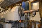 Used Ikegai 65mm Twin Screw Extruder, Model PCM-65II. Liquid heated, and cooled. 8 Zone top vented barrel. Top mounted twin screw feeder. Approximate 64