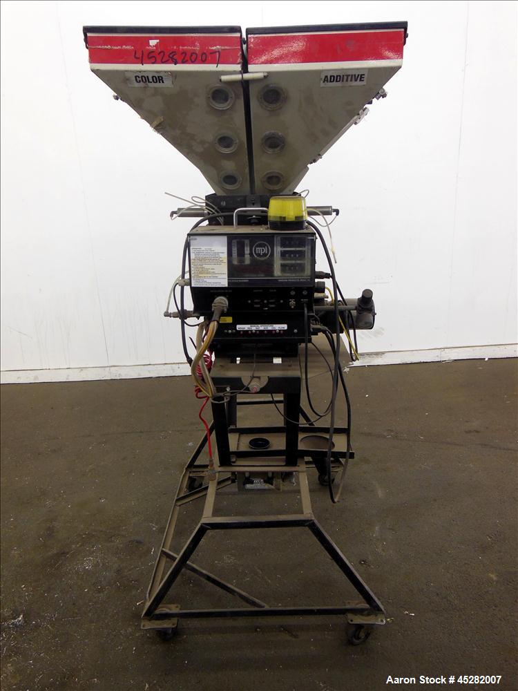 Used McGuire 4 Color Weigh Scale Blender, Model W-140RM1. Mounted on a stand with casters. Serial# 89574.