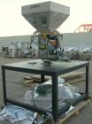 Used AEC Optimum OS Series Gravimetric Batch Blending System, Model OS-007-4, Carbon Steel.  (4) compartments.  Mounted on a carbon steel table.

