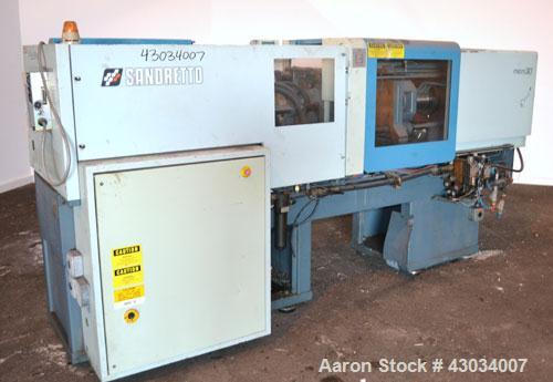 Used Sandretto Micro30 30 Ton Hydraulic Horizontal Injection Mold Machine, Model 300/107. Approximate 1-3/4" diameter tie bars, 12" x 12" distance between bars, 17-3/4" x 17-3/4" platen size. Operato...