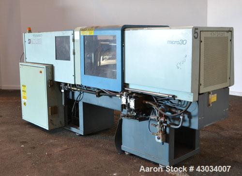 Used Sandretto Micro30 30 Ton Hydraulic Horizontal Injection Mold Machine, Model 300/107. Approximate 1-3/4" diameter tie bars, 12" x 12" distance between bars, 17-3/4" x 17-3/4" platen size. Operato...