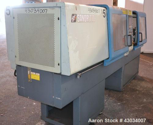 Used Sandretto Micro30 30 Ton Hydraulic Horizontal Injection Mold Machine, Model 300/107. Approximate 1-3/4" diameter tie bars, 12" x 12" distance between bars, 17-3/4" x 17-3/4" platen size. Operato...