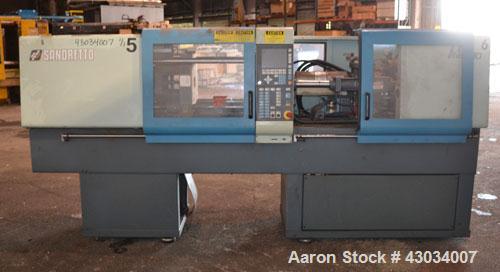 Used Sandretto Micro30 30 Ton Hydraulic Horizontal Injection Mold Machine, Model 300/107. Approximate 1-3/4" diameter tie bars, 12" x 12" distance between bars, 17-3/4" x 17-3/4" platen size. Operato...