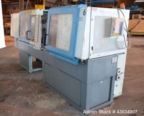 Used Sandretto Micro30 30 Ton Hydraulic Horizontal Injection Mold Machine, Model 300/107. Approximate 1-3/4" diameter tie bars, 12" x 12" distance between bars, 17-3/4" x 17-3/4" platen size. Operato...