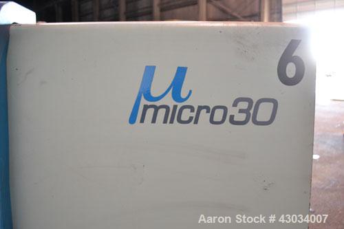 Used Sandretto Micro30 30 Ton Hydraulic Horizontal Injection Mold Machine, Model 300/107. Approximate 1-3/4" diameter tie bars, 12" x 12" distance between bars, 17-3/4" x 17-3/4" platen size. Operato...