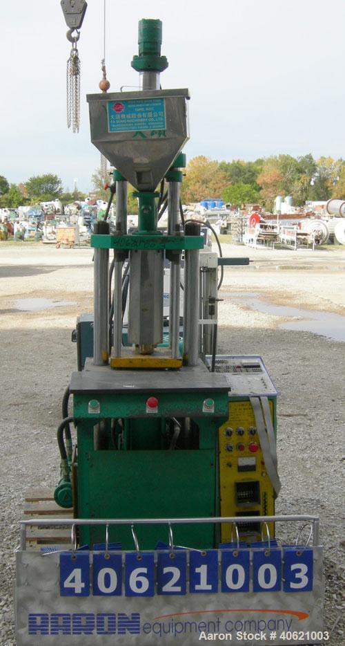 Used Ta So Machinery Vertical Injection Molder. (2) 2 1/2" diameter tie bars. Top platen 10 3/4" x 10 3/4". Driven by a 5 hp, 3/60/220/380 volt, 1160 rpm hydraulic power pack.