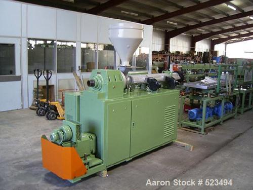 USED: PVC profile line. Cincinnati CMT-35 twin screw extruder, screwdiameter 1.38" to 2.95" (35-75mm) conical, screw length 31" (790mm),DC motor 9 kw. Includes monitor control, Dozer DOT-35, vacuum p...