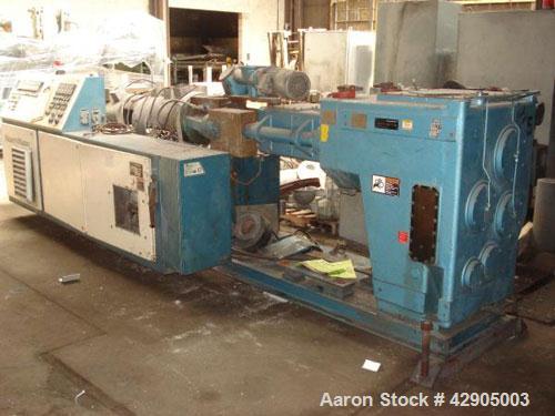Used Krauss Maffei 110mm counter rotating twin screw extruder, model KMD-2-110Z, 110 mm screws, counter rotating, 25:1 l/d, electrically heated with 9 barrel zones, 17 die zones, 75 hp dc motor with ...