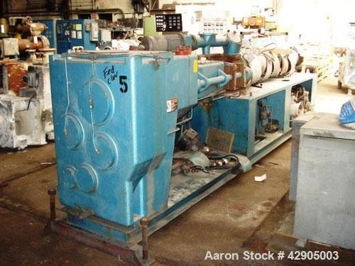 Used Krauss Maffei 110mm counter rotating twin screw extruder, model KMD-2-110Z, 110 mm screws, counter rotating, 25:1 l/d, electrically heated with 9 barrel zones, 17 die zones, 75 hp dc motor with ...