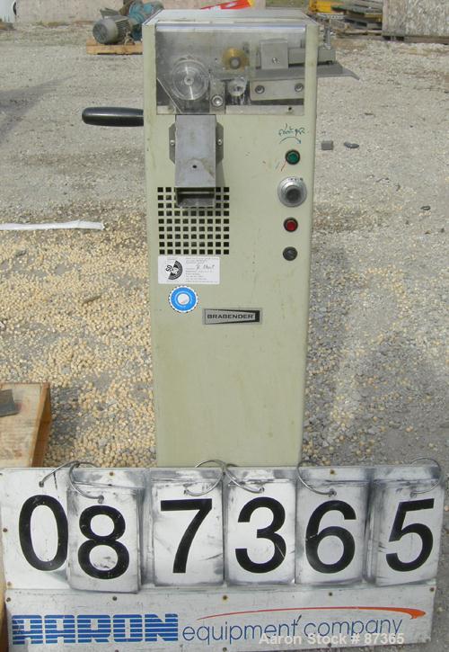 USED: Brabender 2" wide strand pelletizer, type 881203. Approximate 12 knife helical rotor. 50 hertz, 230 volt control. Spring adjustable tension, metal pull rolls. Mounted on a portable cart on whee...