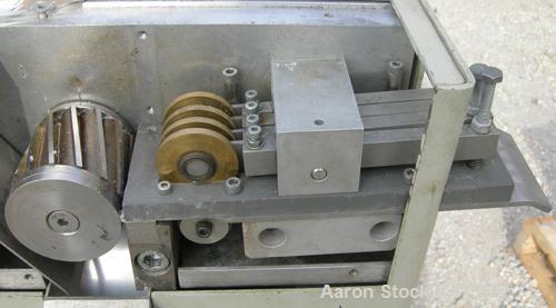 USED: Brabender 2" wide strand pelletizer, type 881203. Approximate 12 knife helical rotor. 50 hertz, 230 volt control. Spring adjustable tension, metal pull rolls. Mounted on a portable cart on whee...