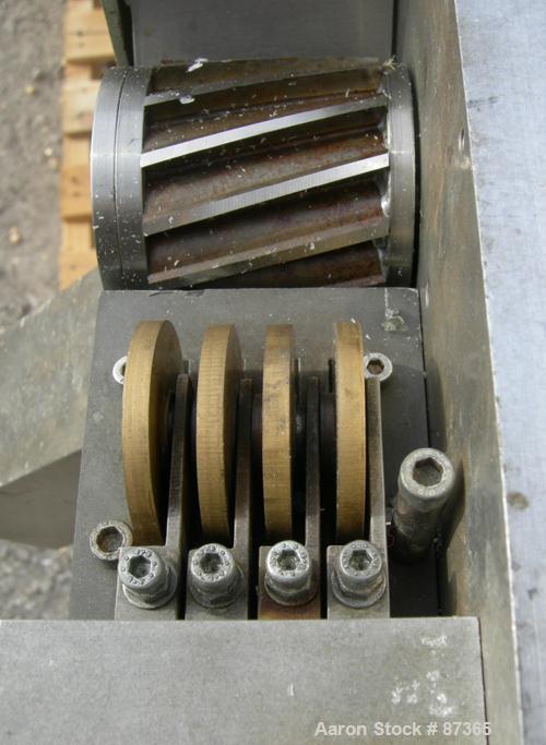 USED: Brabender 2" wide strand pelletizer, type 881203. Approximate 12 knife helical rotor. 50 hertz, 230 volt control. Spring adjustable tension, metal pull rolls. Mounted on a portable cart on whee...